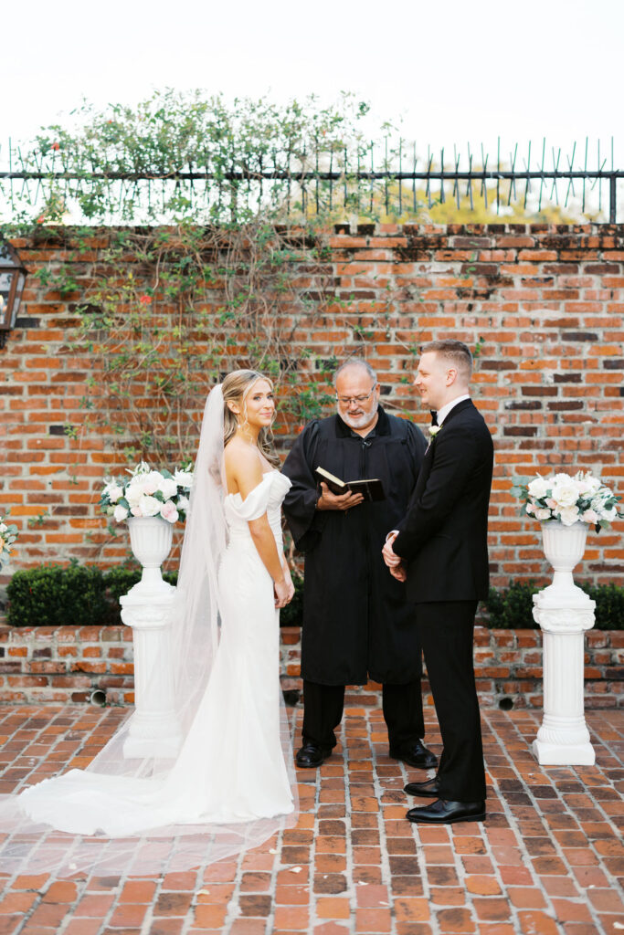 Bride and groom exchanging vows at their Maison de Tours wedding