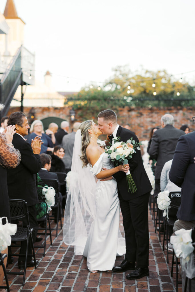 The first kiss as newlyweds in the courtyard of Maison de Tours