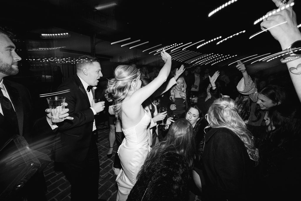 Guests celebrating under the string lights at Maison de Tours