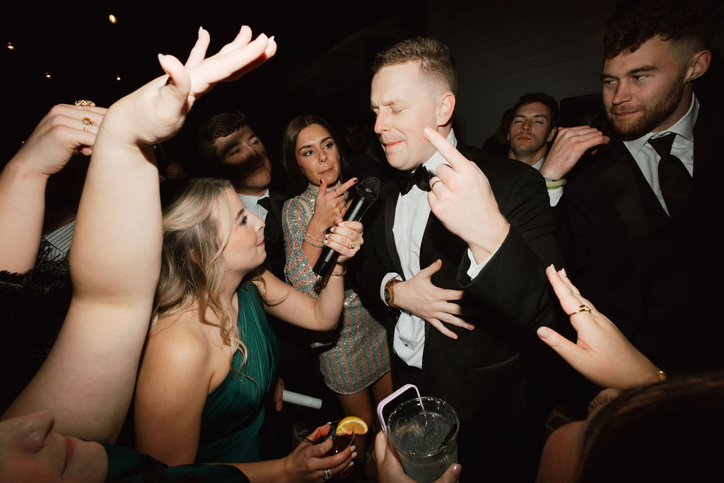 Guests dancing at the outdoor reception in the courtyard