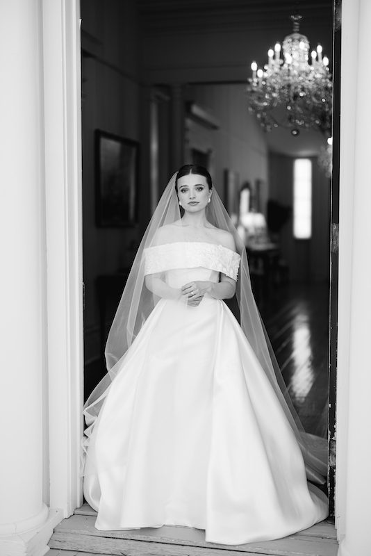 Soft golden light illuminating a bride on a historic Louisiana estate.