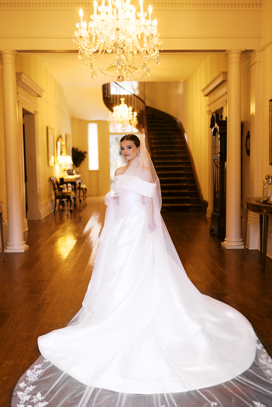 Bride gazing out over the lush, manicured grounds of Greenwood Plantation.