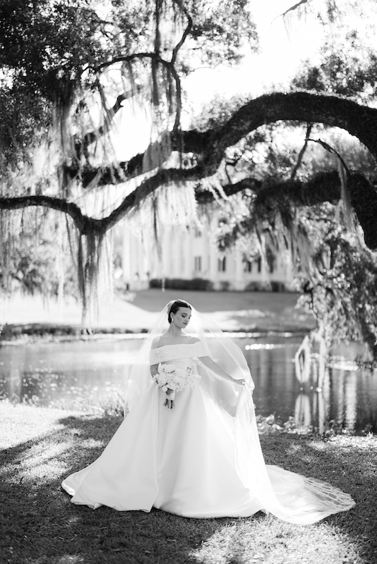 Southern bride posing on the front porch during her bridal portraits at Greenwood Plantation.