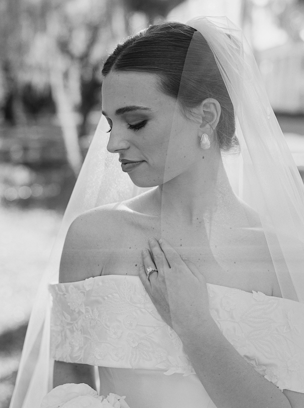 Classic Southern bride posing in front of grand white columns.