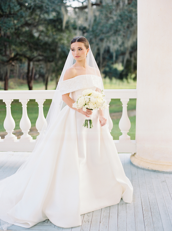 Soft golden light illuminating a bride on a historic Louisiana estate.