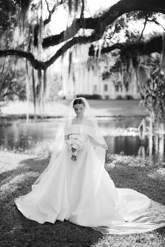 Bride twirling in a ball gown during her bridal portraits at Greenwood Plantation.